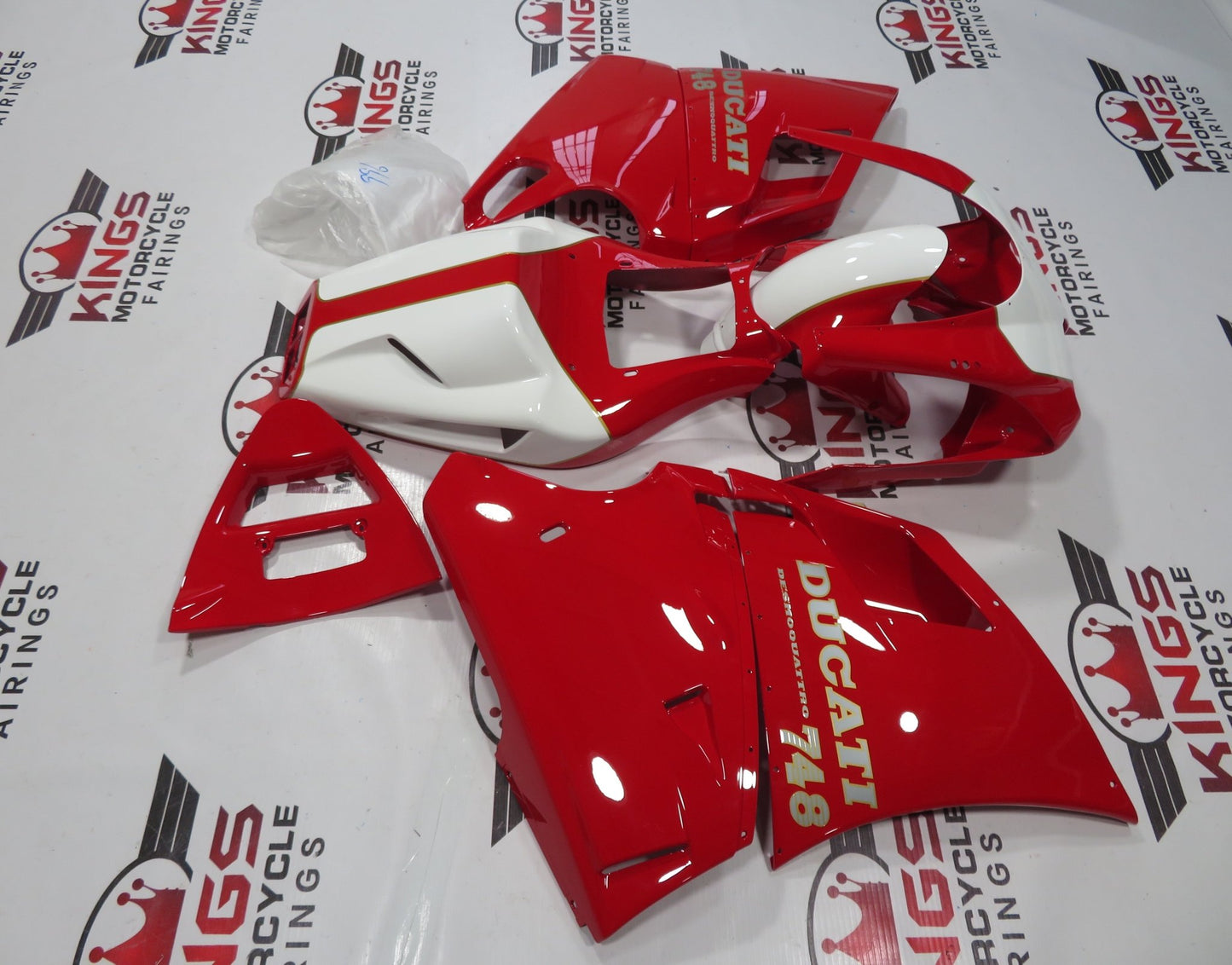 Red, White, Silver and Gold Pinstripe Fairing Kit for a 1998, 1999, 2000, 2001, & 2002 Ducati 996 motorcycle. The photos used are examples of the paint design. Your Ducati 996 will have 996 sticker decals, not 748 decals