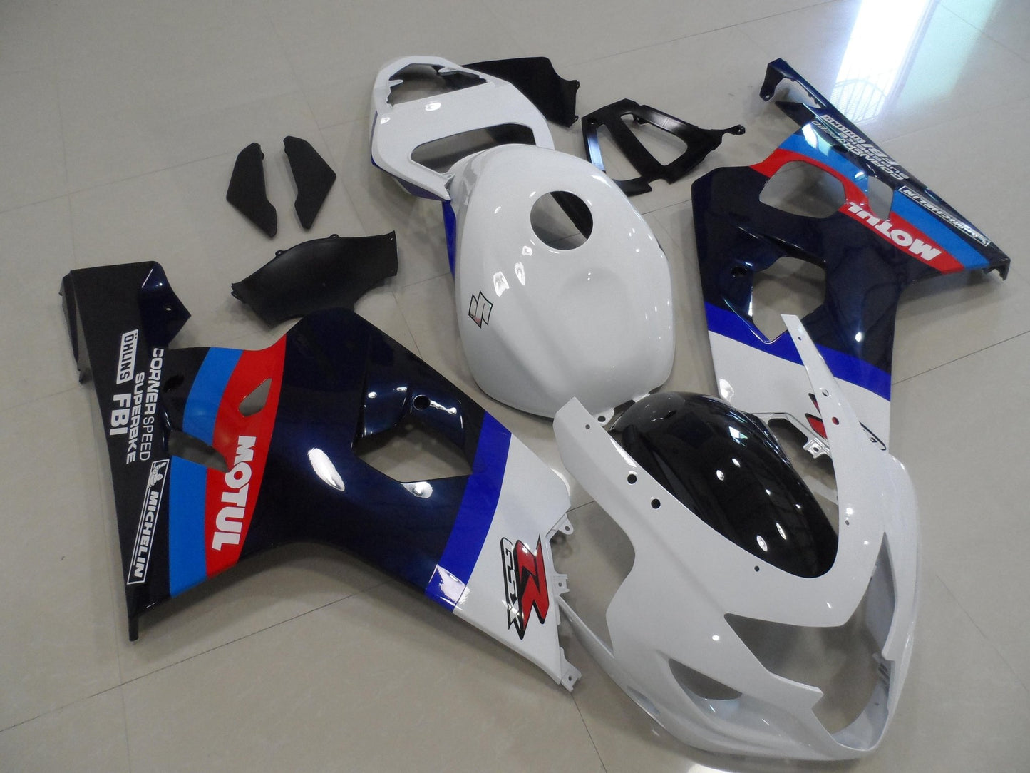 White, Blue, Black, Dark Blue and Red Fairing Kit for a 2004 & 2005 Suzuki GSX-R600 motorcycle.