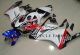 White, Black, Red and Blue Carrera Fairing Kit for a 2004 & 2005 Honda CBR1000RR motorcycle.